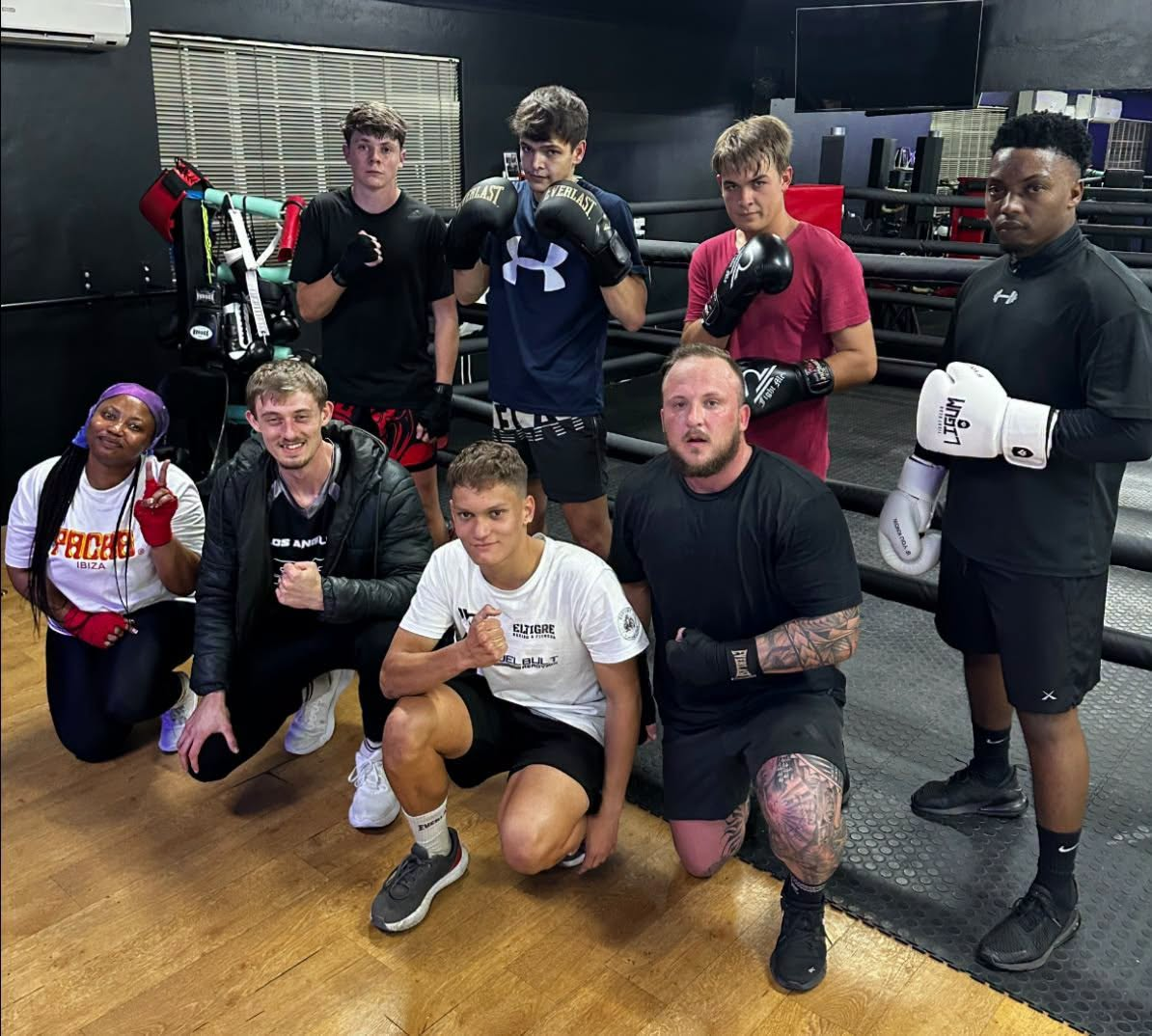 Group of boxers with gloves inside the ring