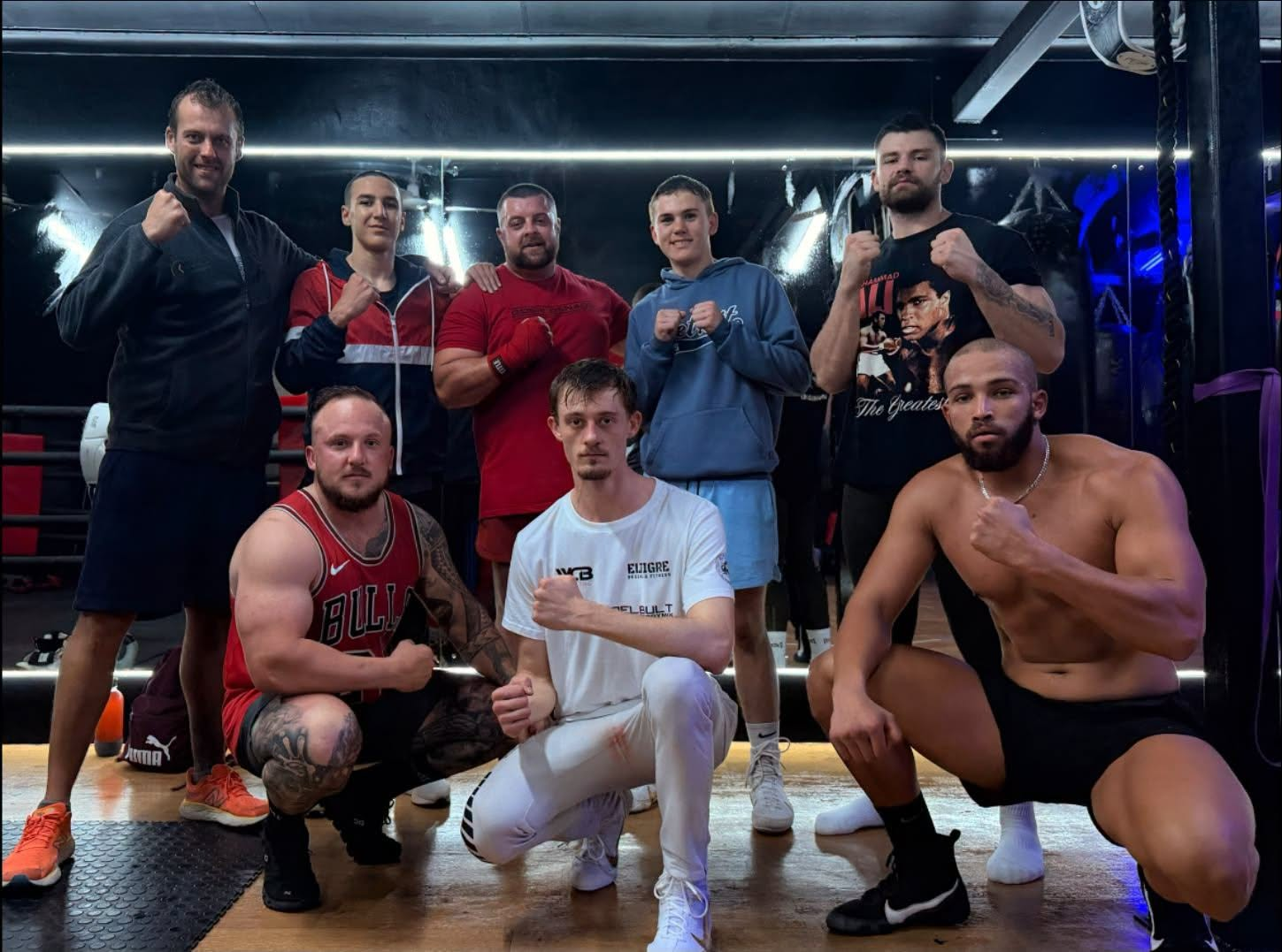 Fighters posing with fists up after a training session
