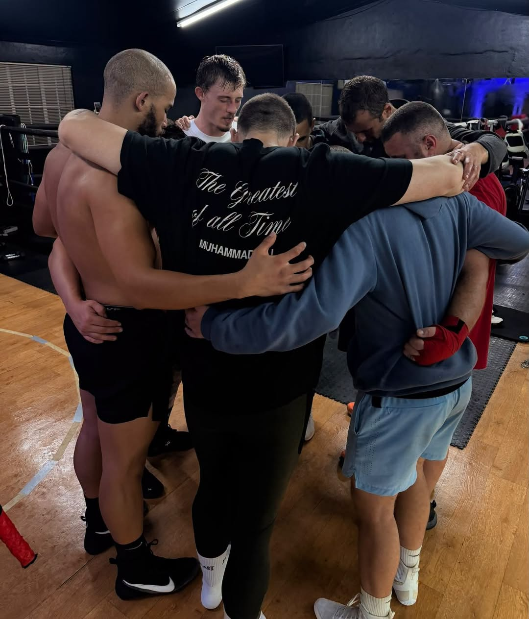 The team huddled together in prayer after training