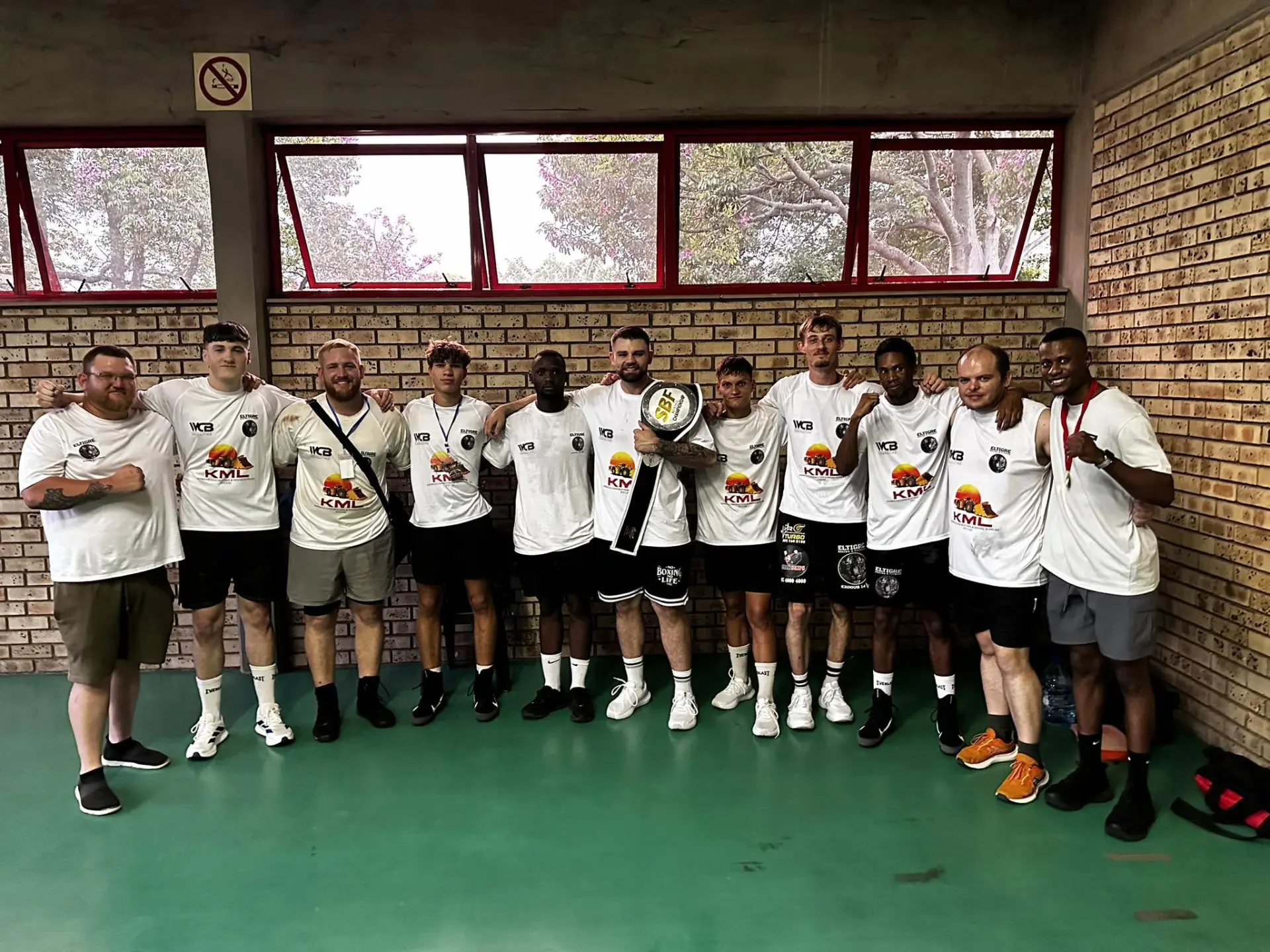 El Tigre Boxing team with a championship belt